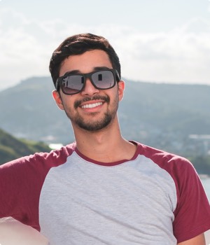 man-wearing-gray-and-red-crew-neck-shirt-smiling-1121796